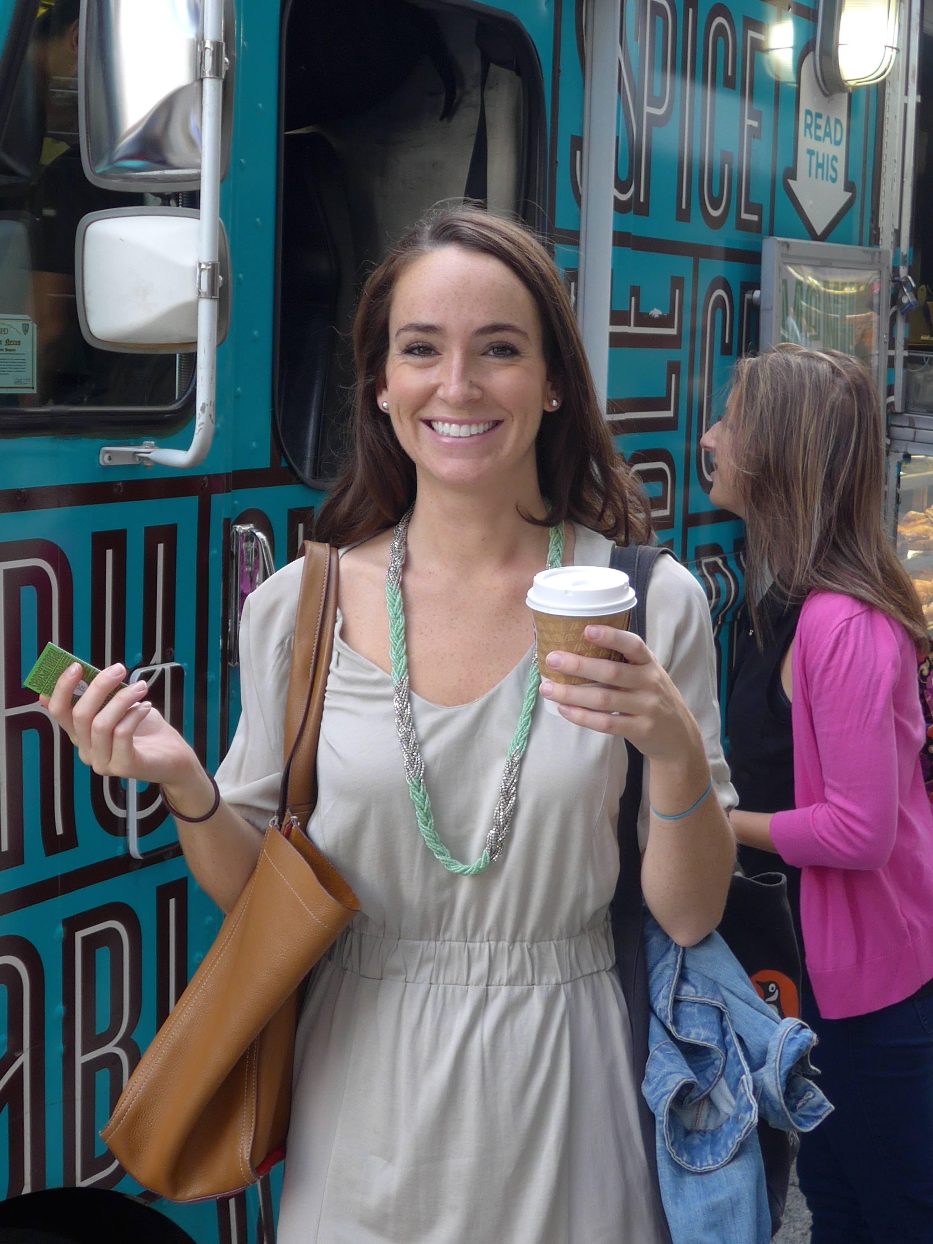 smiling_customer_holding_hot_beverage